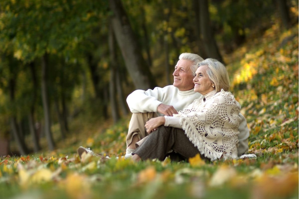 Senior couple sitting in a colourful park