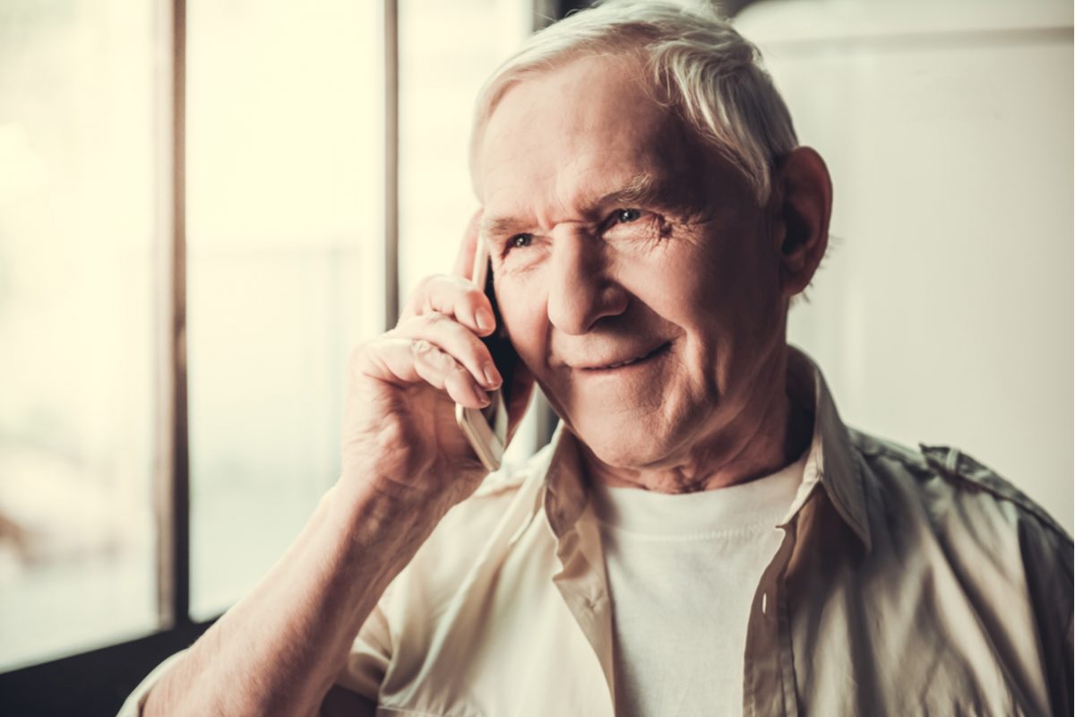 An older man speaking on a mobile phone