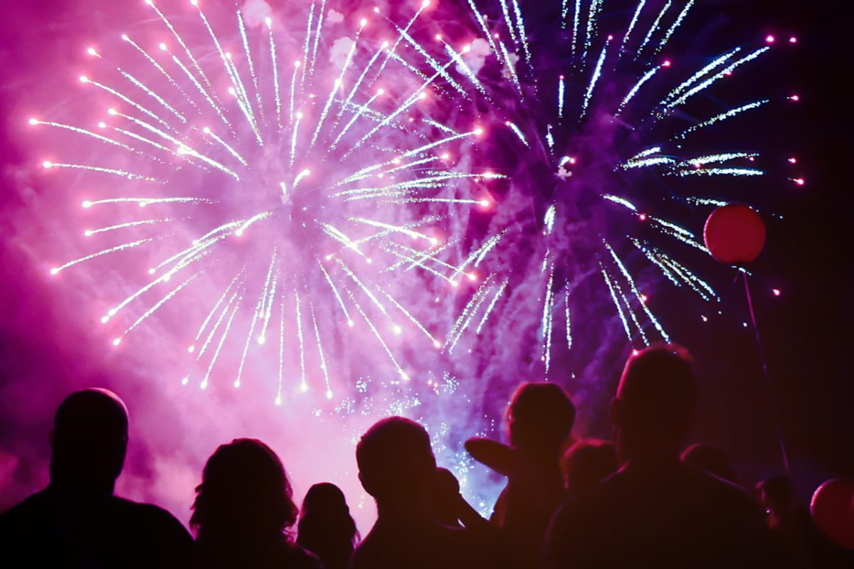 A crowd of people watching a fireworks display