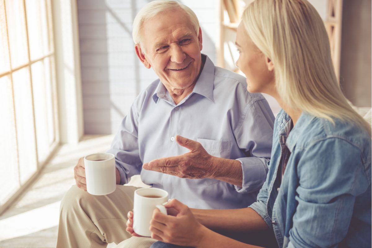 An older man enjoying a coffee with a his daughter