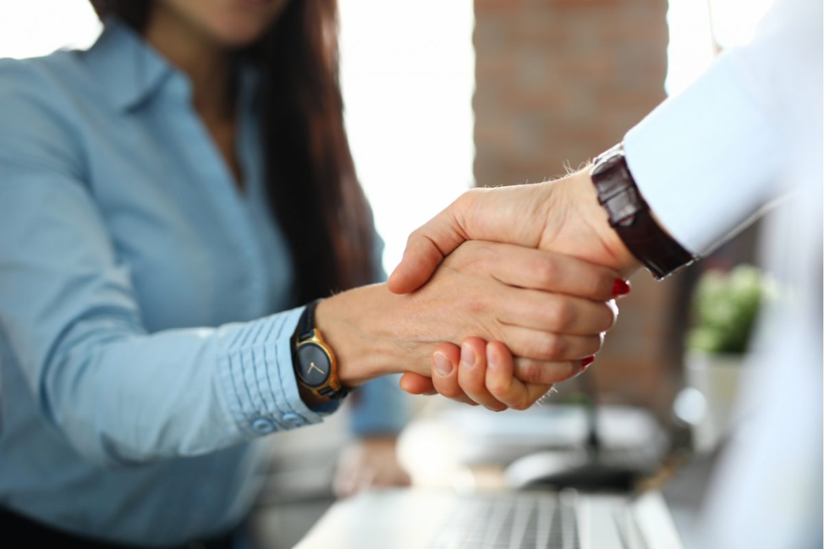 A close up of two business people shaking hands