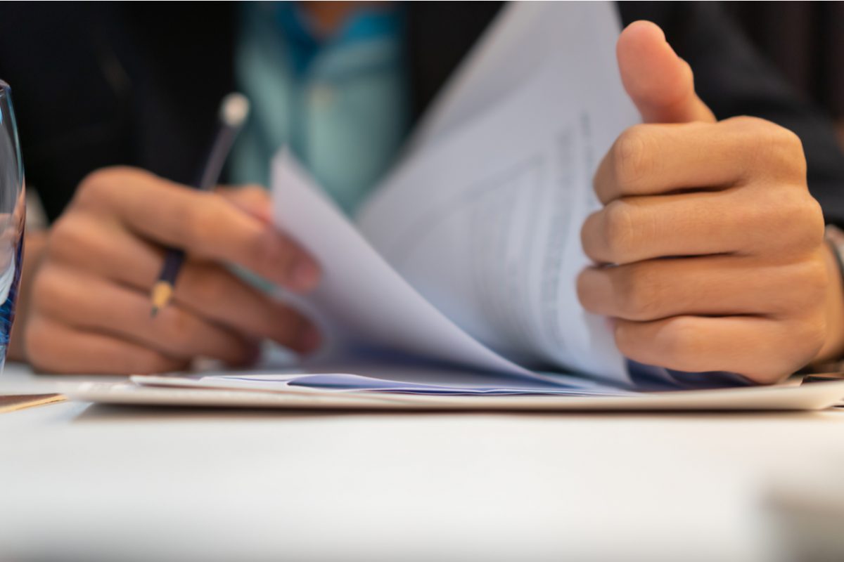 Close up of a man looking through some paperwork