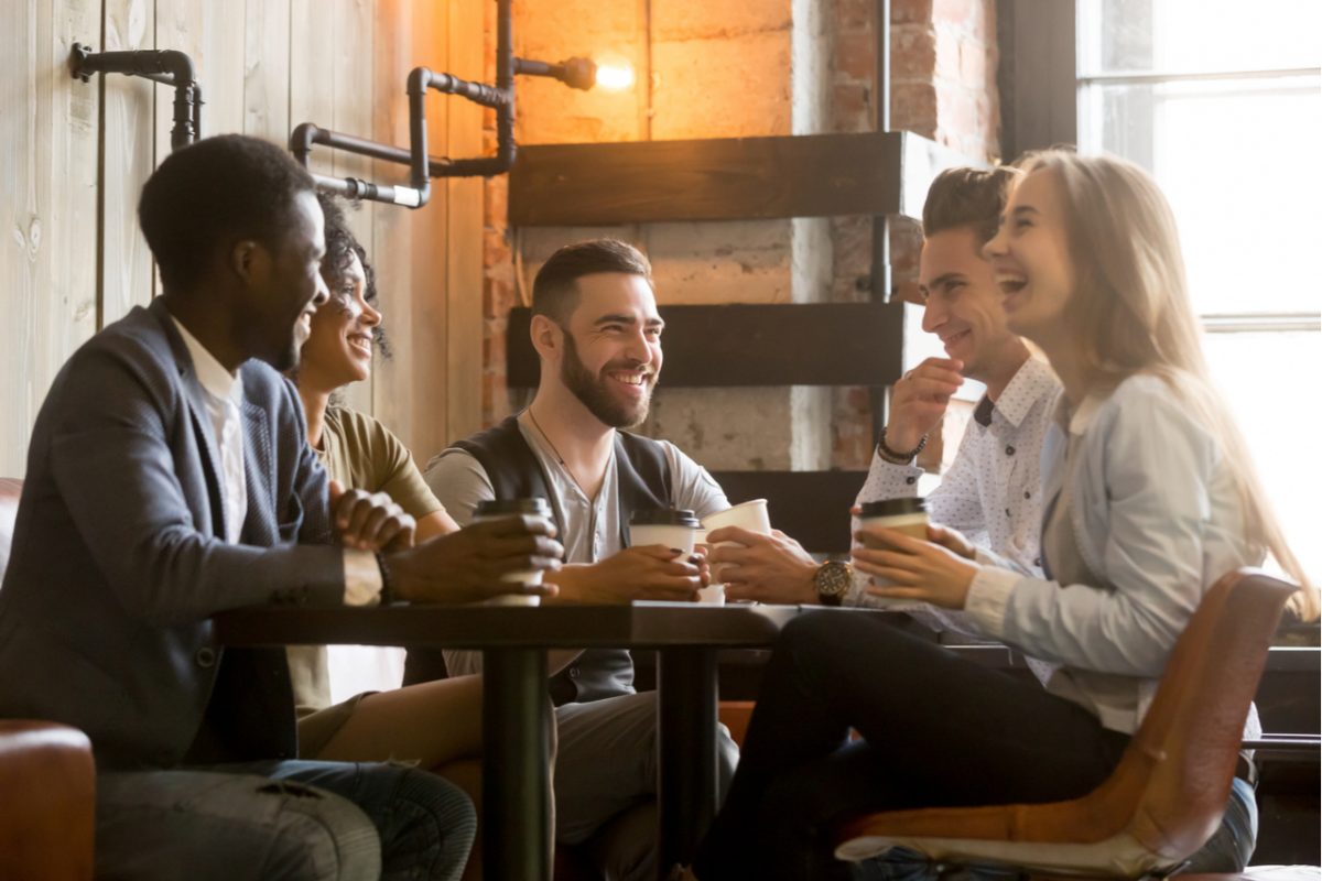 A group of young people enjoying a drink at a café.