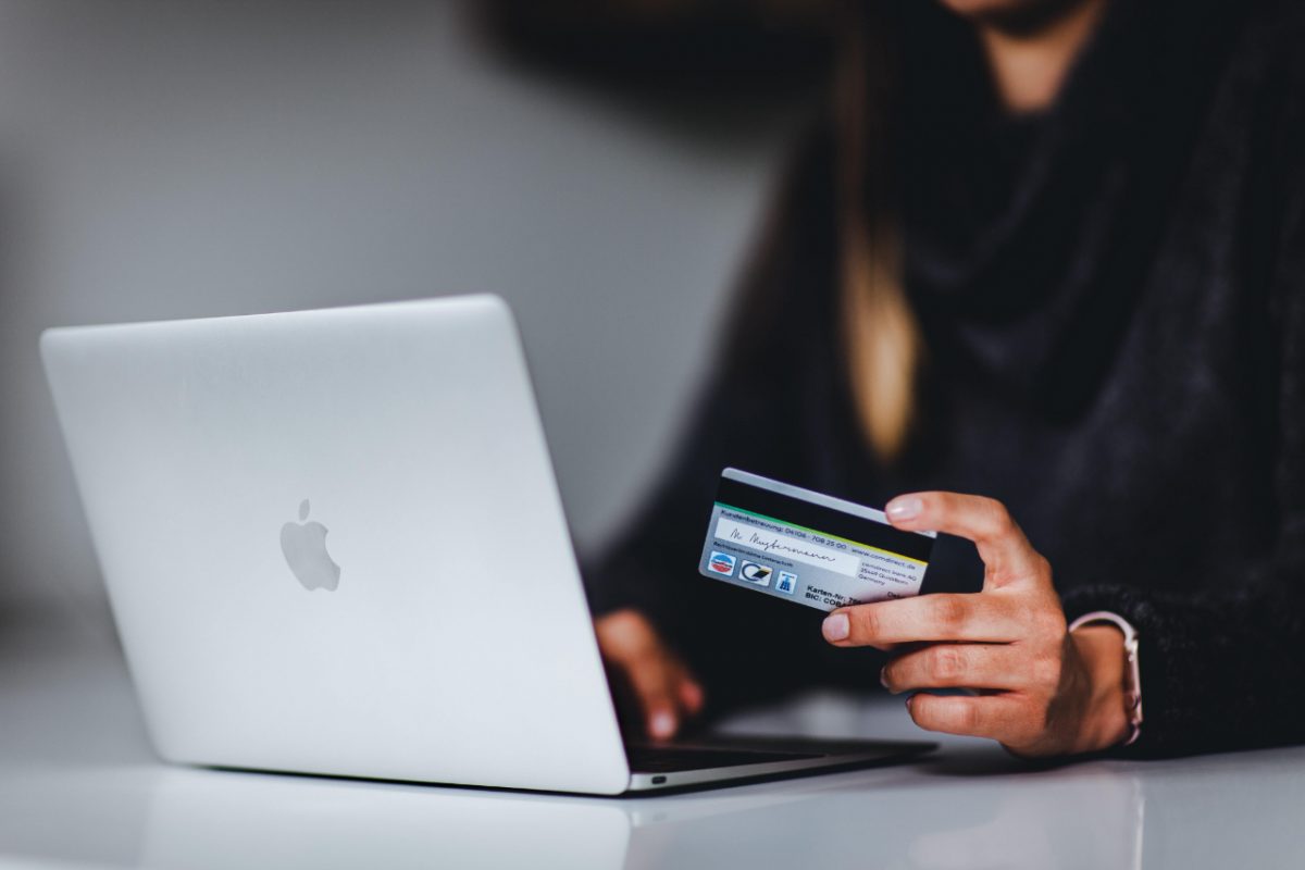 A woman using a bank card to pay for goods online