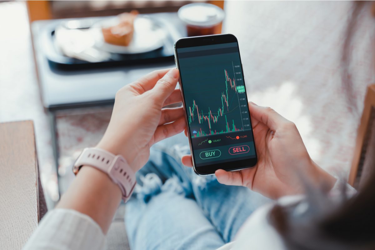 A woman looking at investment performance on a phone.