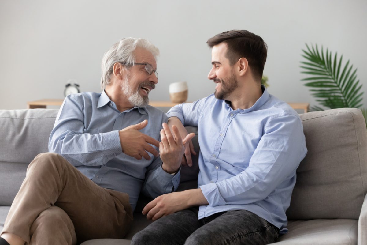 Father and adult son talking.