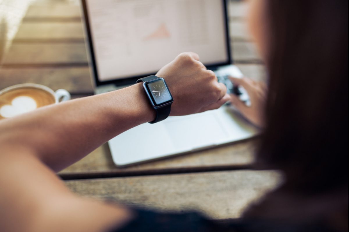 A woman checking the time on a watch.