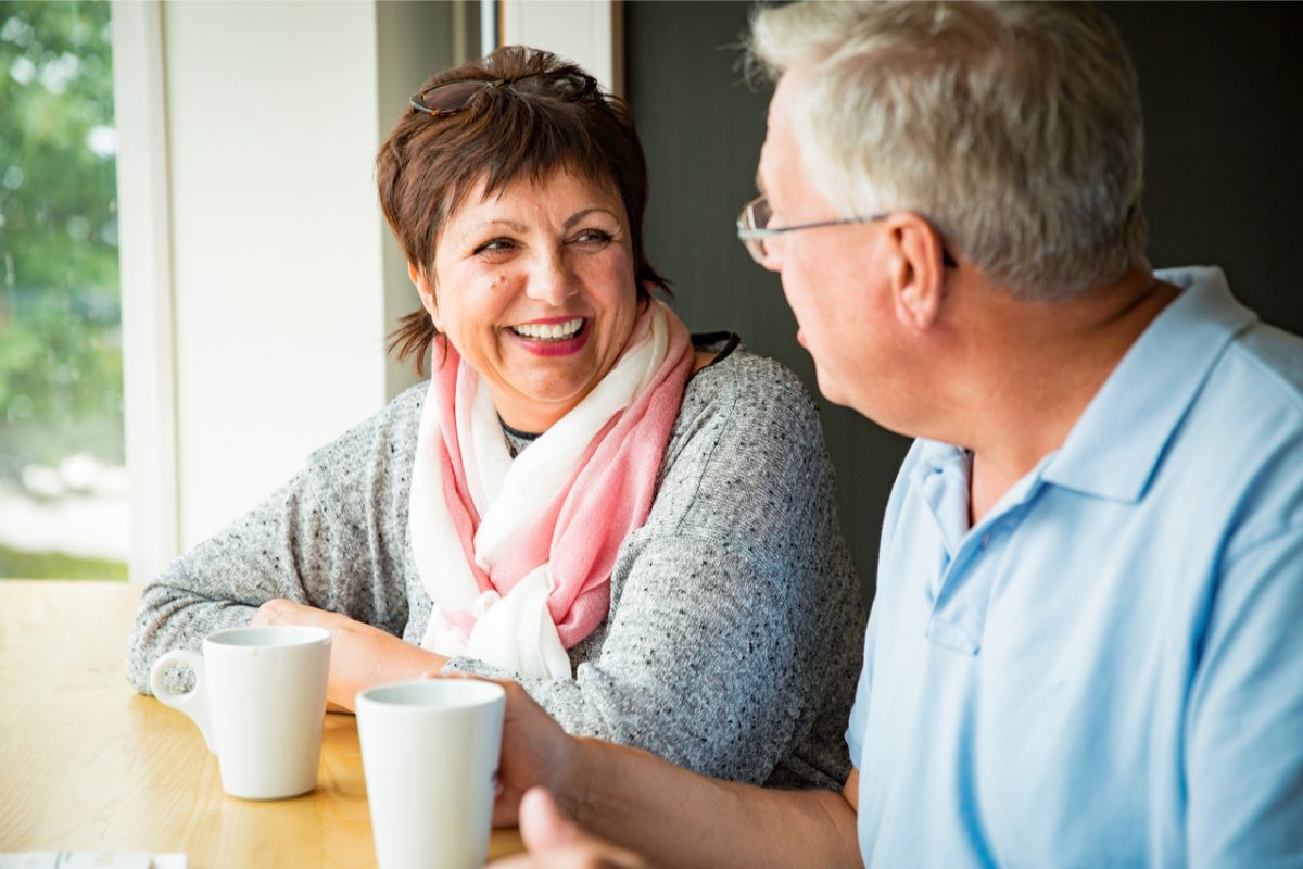 A couple talking over a coffee.