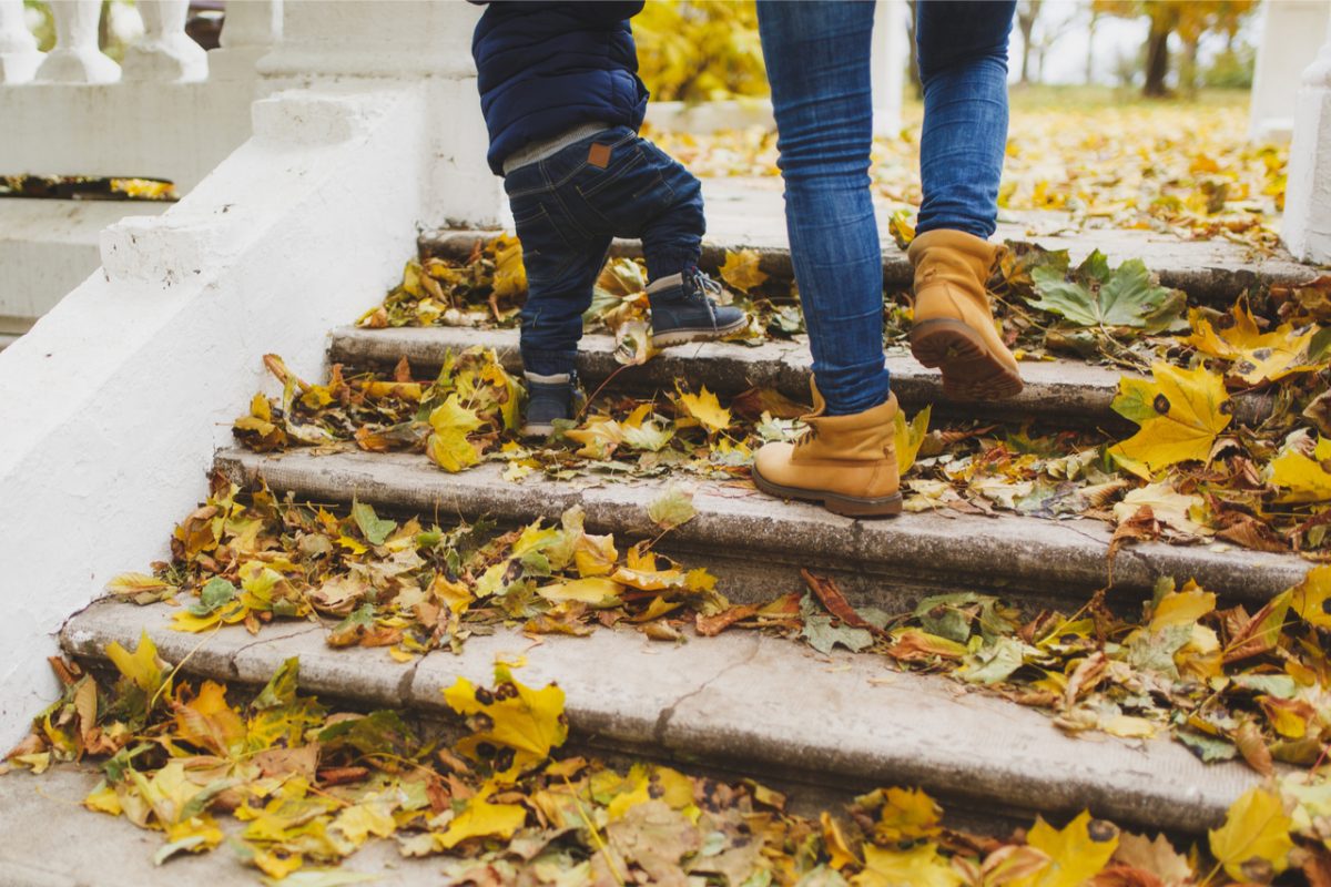 A woman and child walking up some steps.