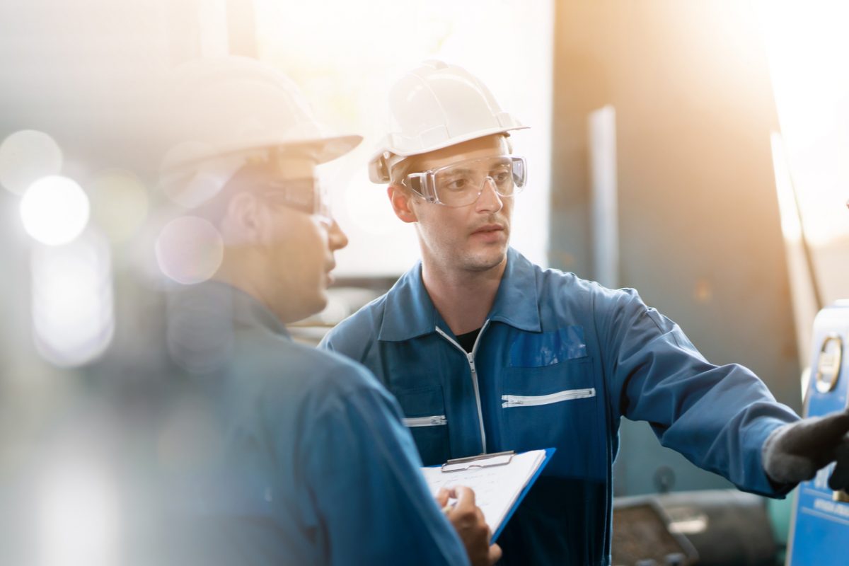 Two workers in a factory.