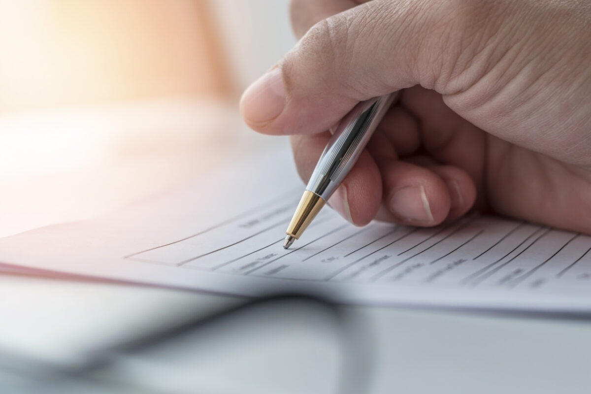 A person filling in paperwork.