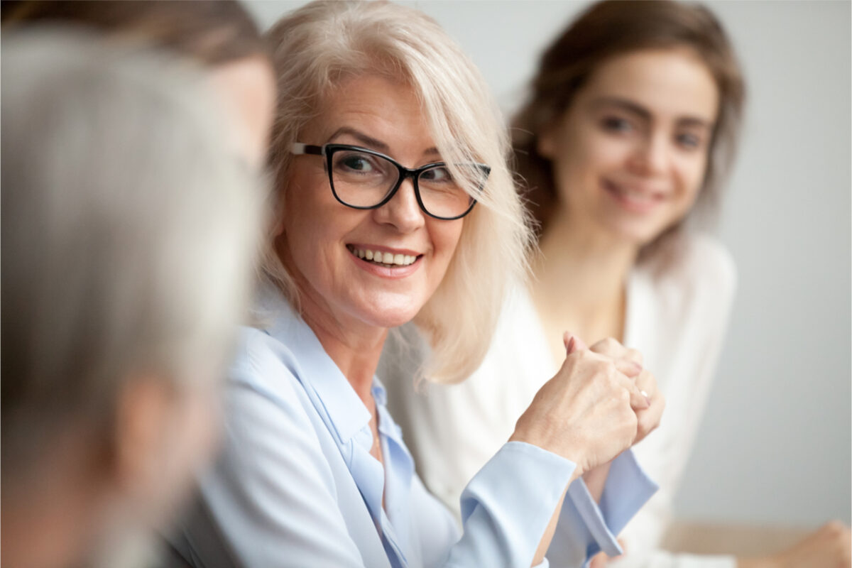 A businesswoman smiling with colleagues.