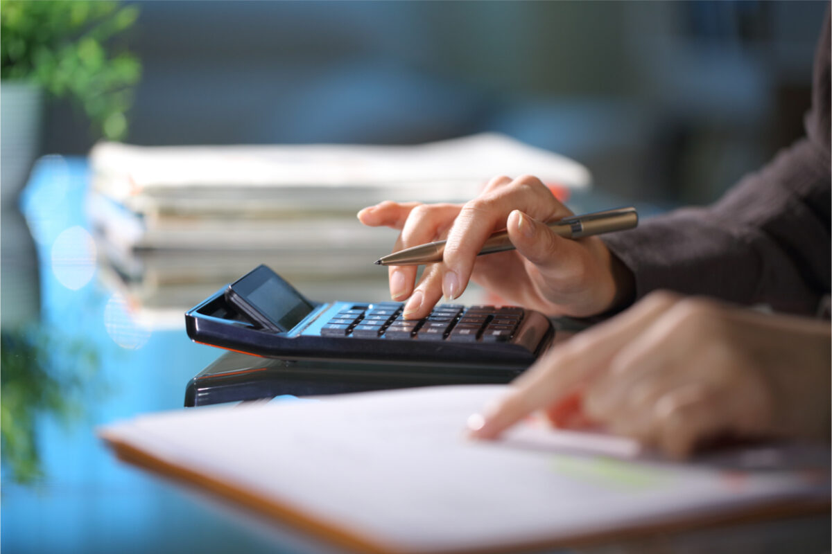 Close-up of a person using a calculator.