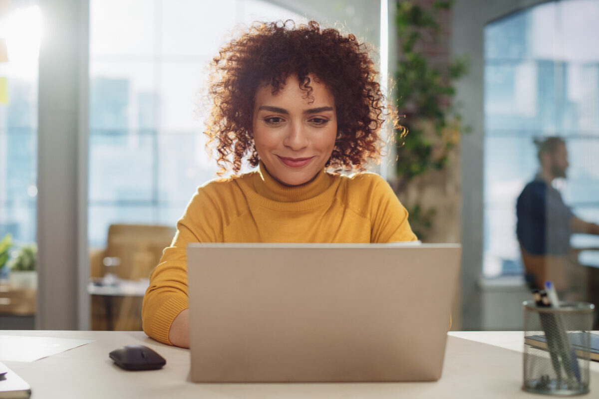 A woman using a laptop.