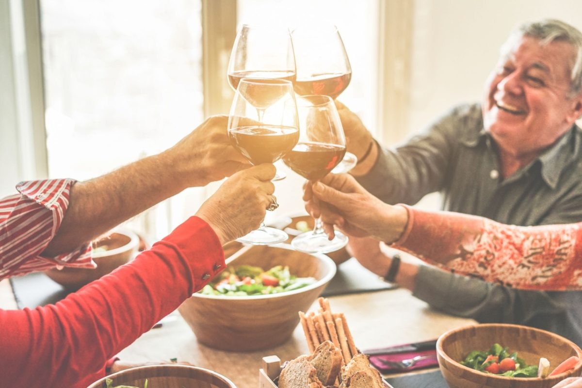 A group of friends cheering with wine.