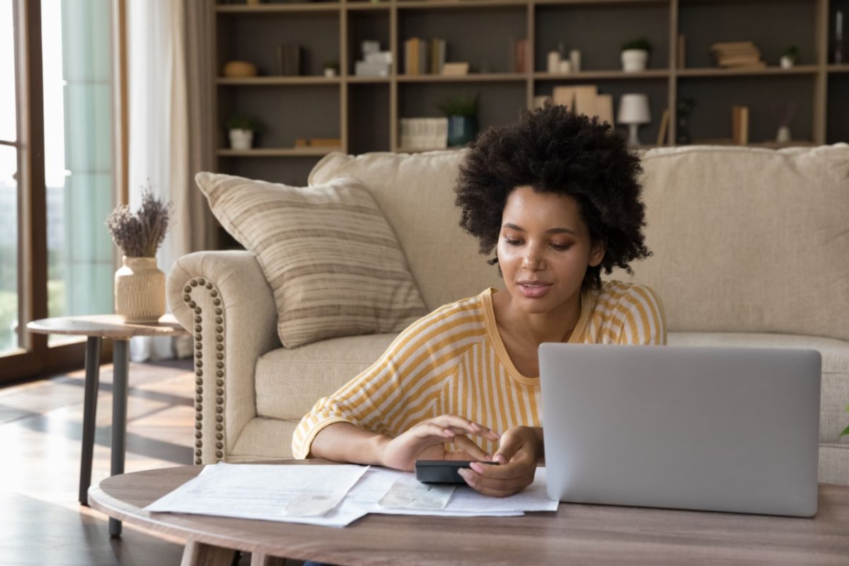 A woman reviewing some paperwork at home.