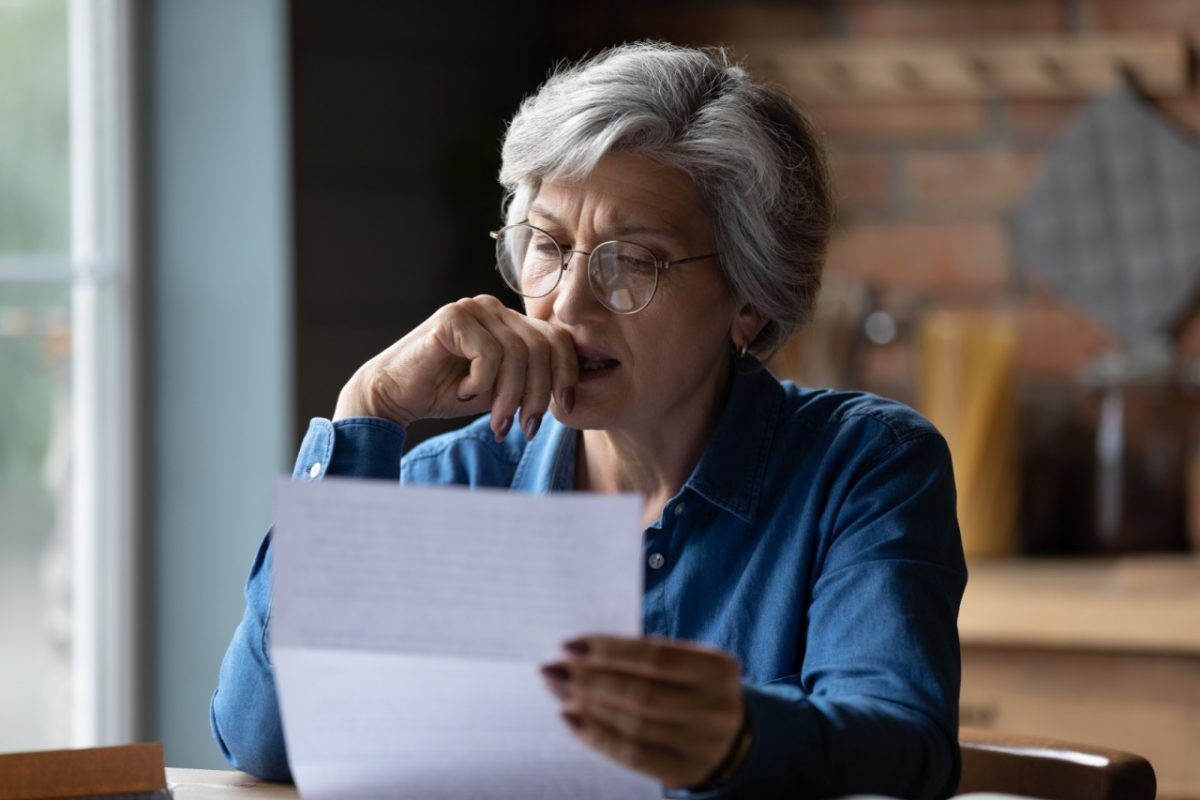 A woman reading a letter.