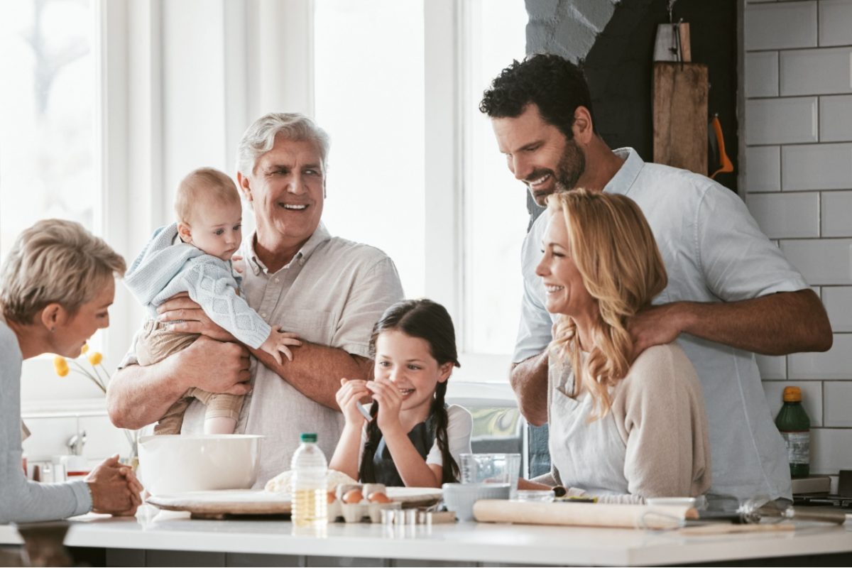 Three generations of family cooking in the kitchen